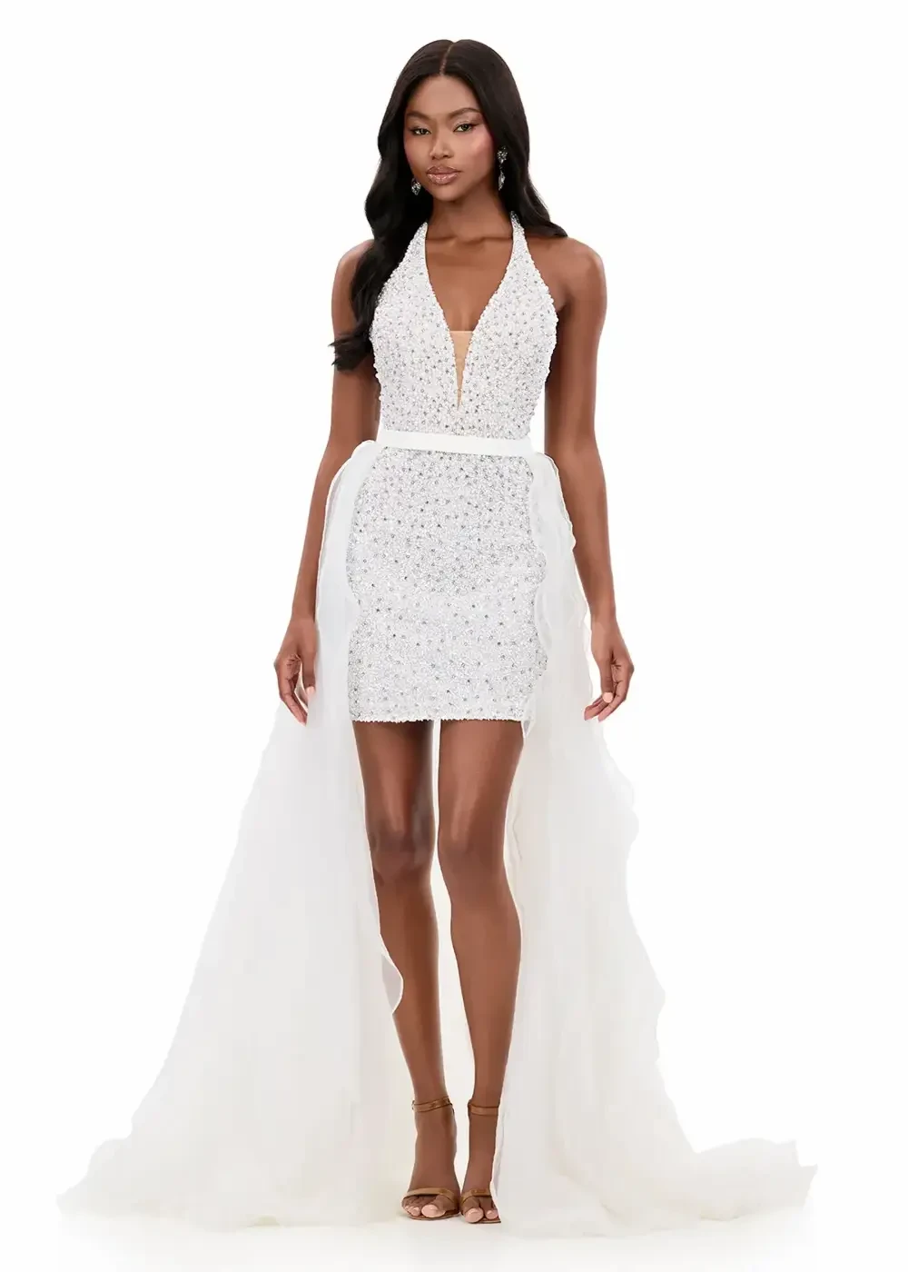 model is wearing a sleeveless sparkly white mini dress with an overskirt