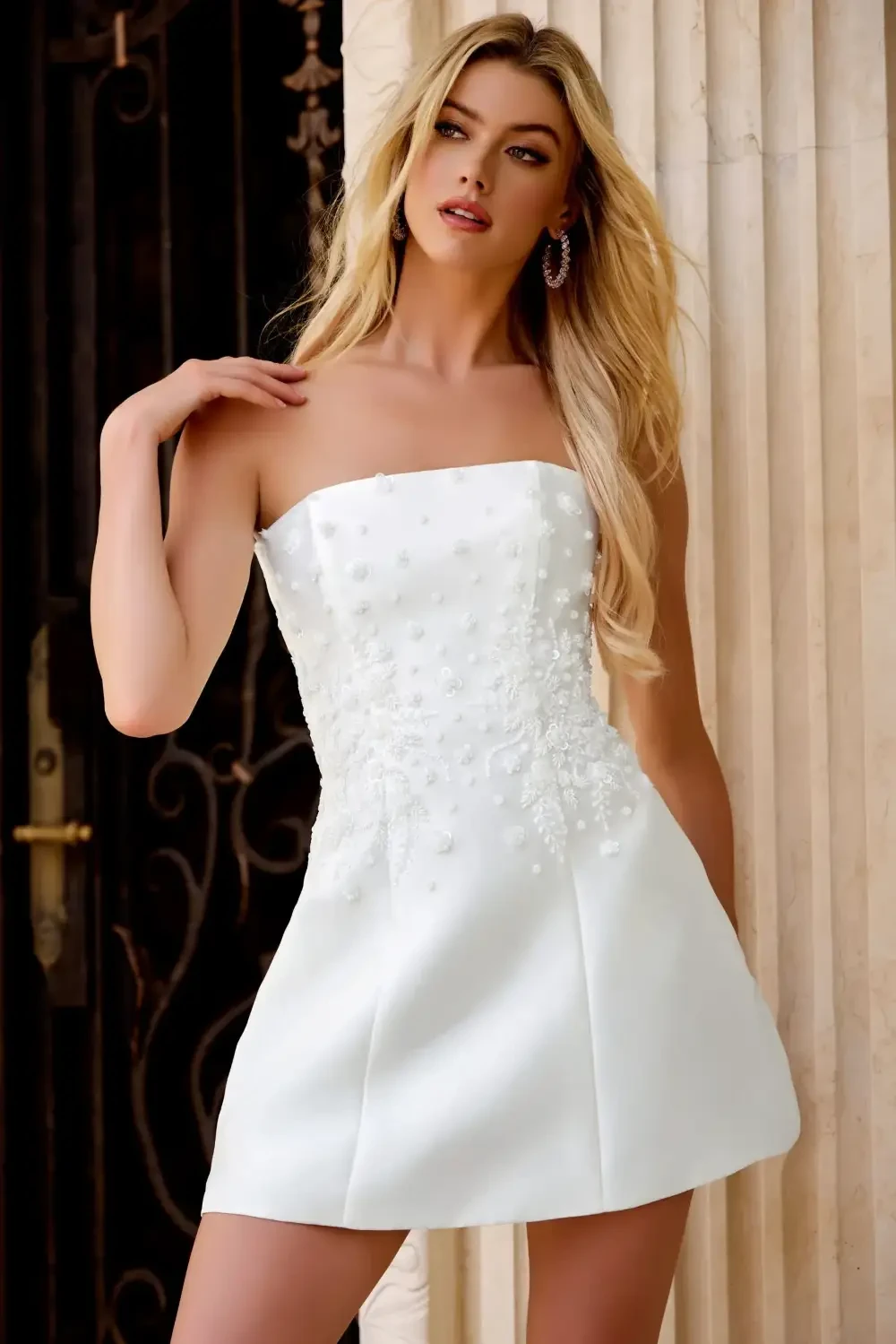 model is wearing a strapless white mini dress