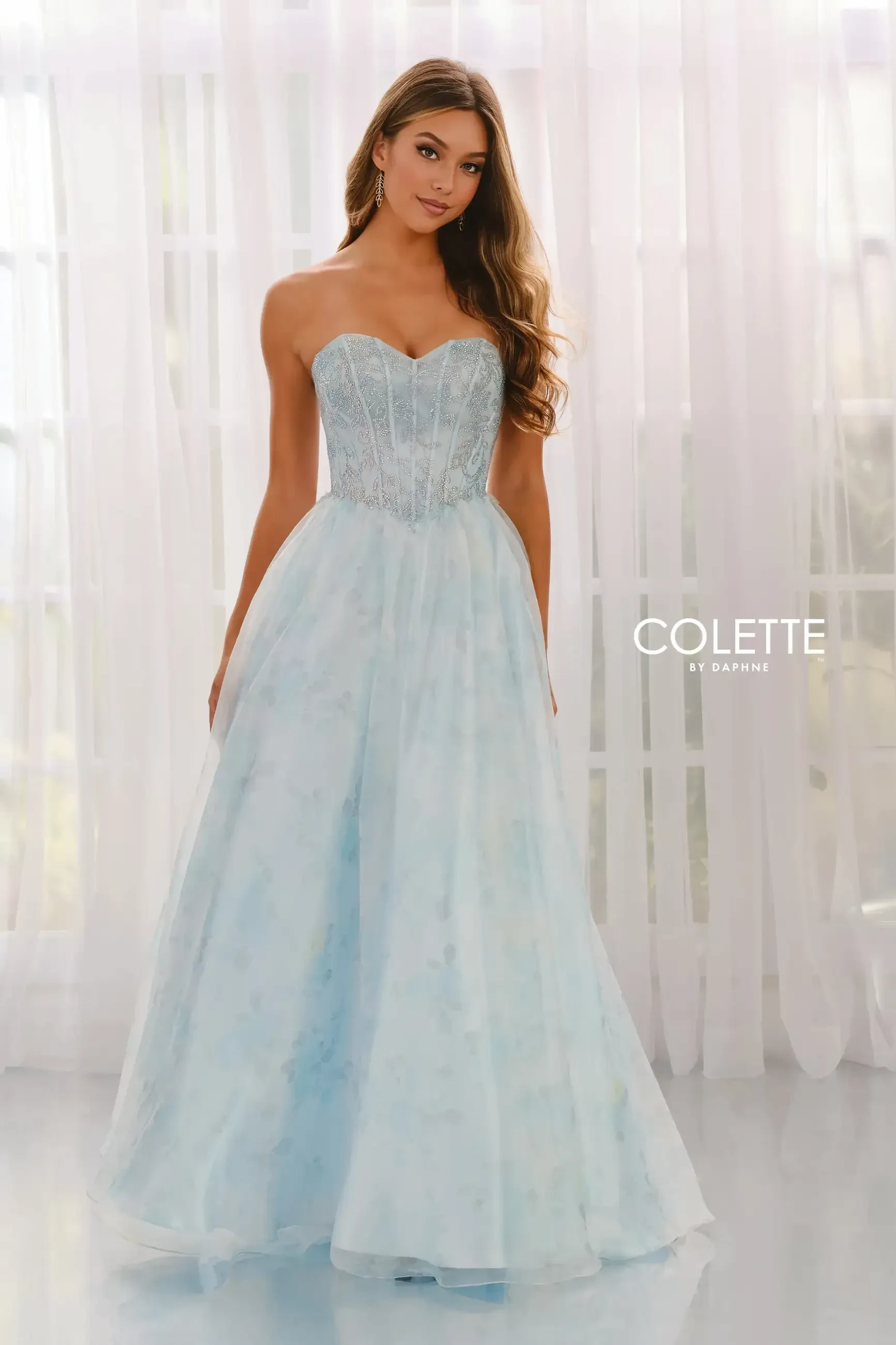 model is wearing an a-line light blue prom dress