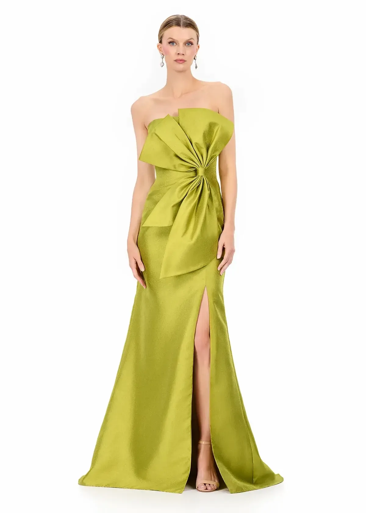 A model wearing an off-the-shoulder, lime green evening gown with a large bow detail and a thigh-high slit.
