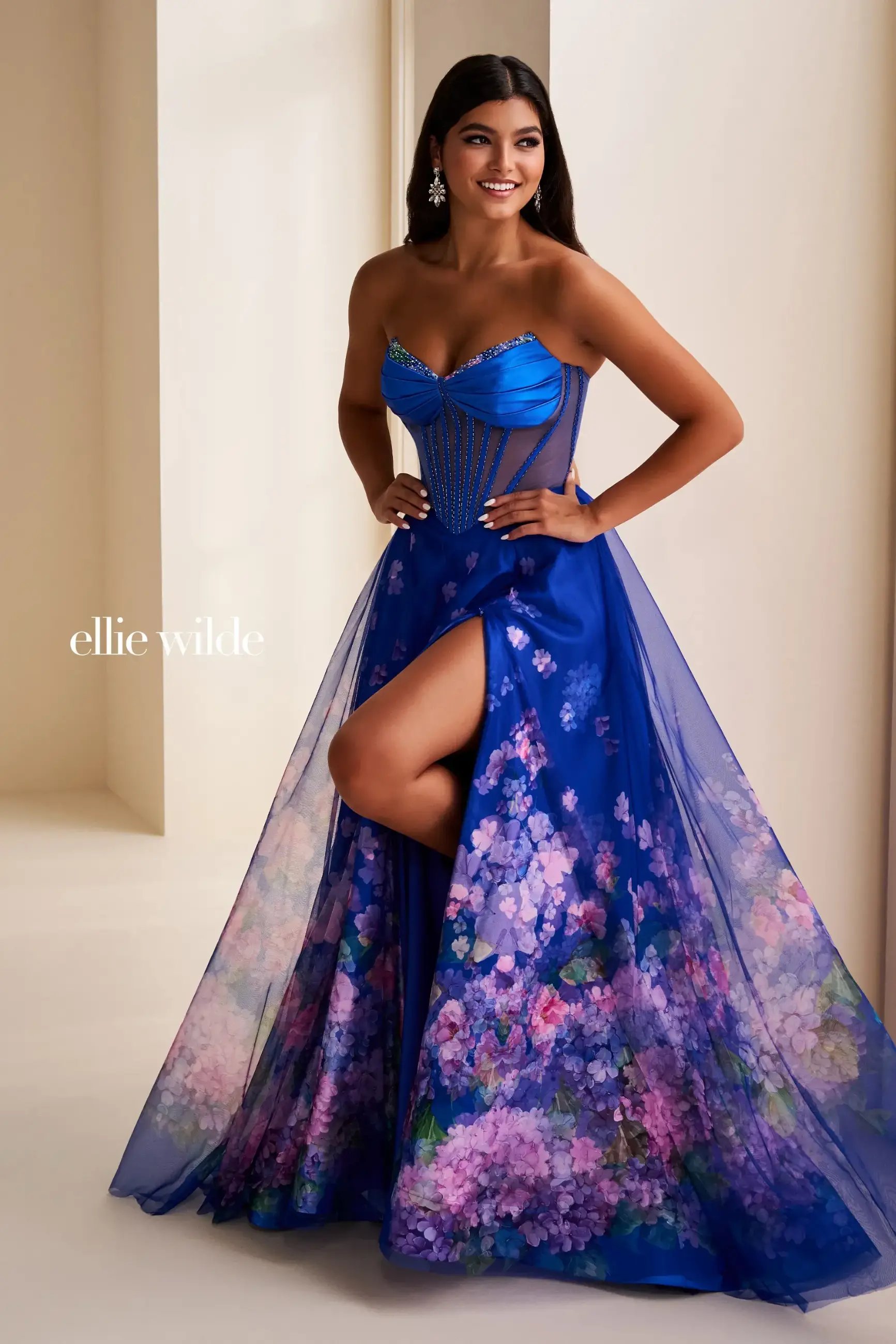 model is wearing a blue a-line floral prom dress