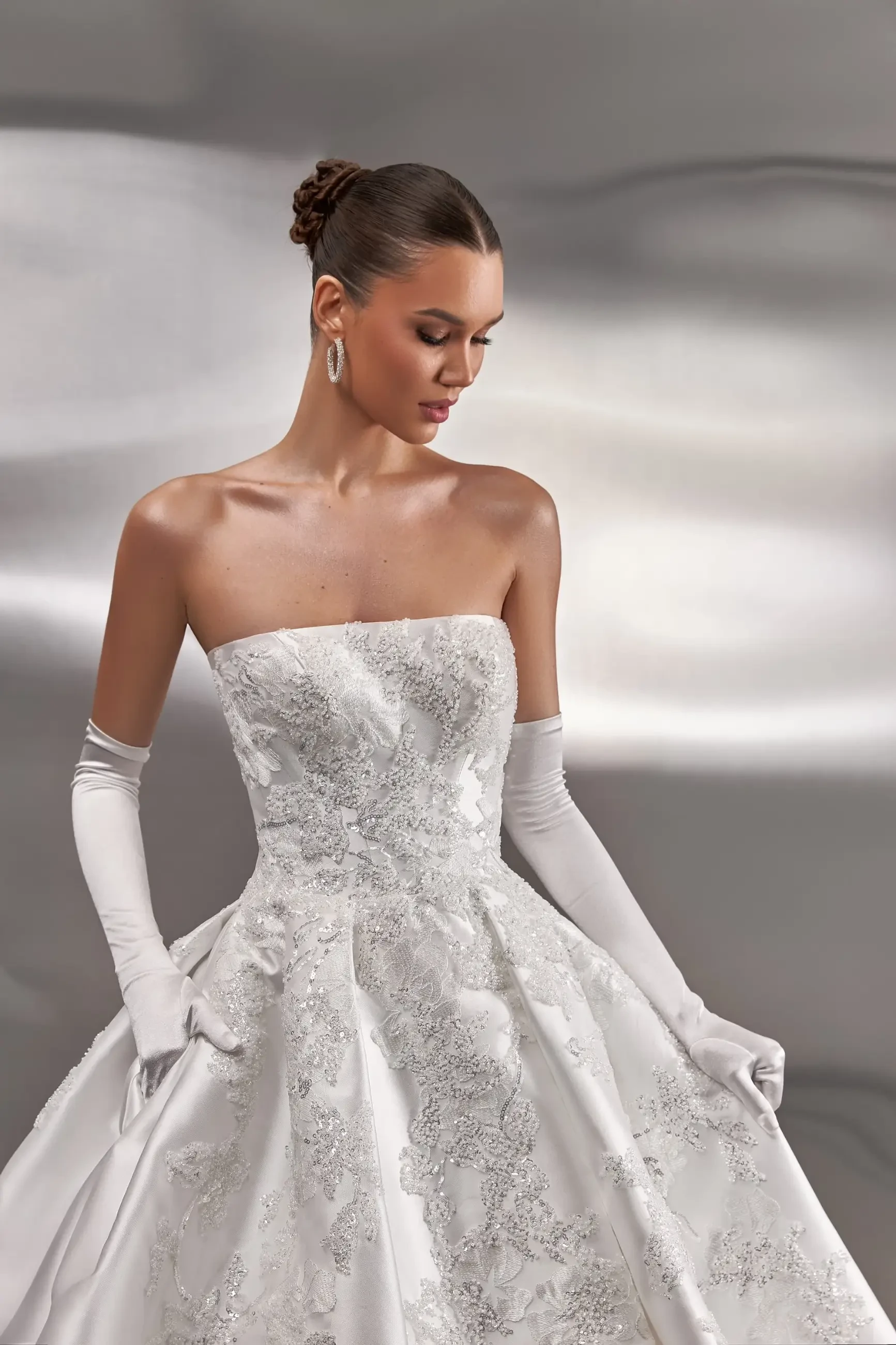 model is wearing a strapless jacquard bridal gown