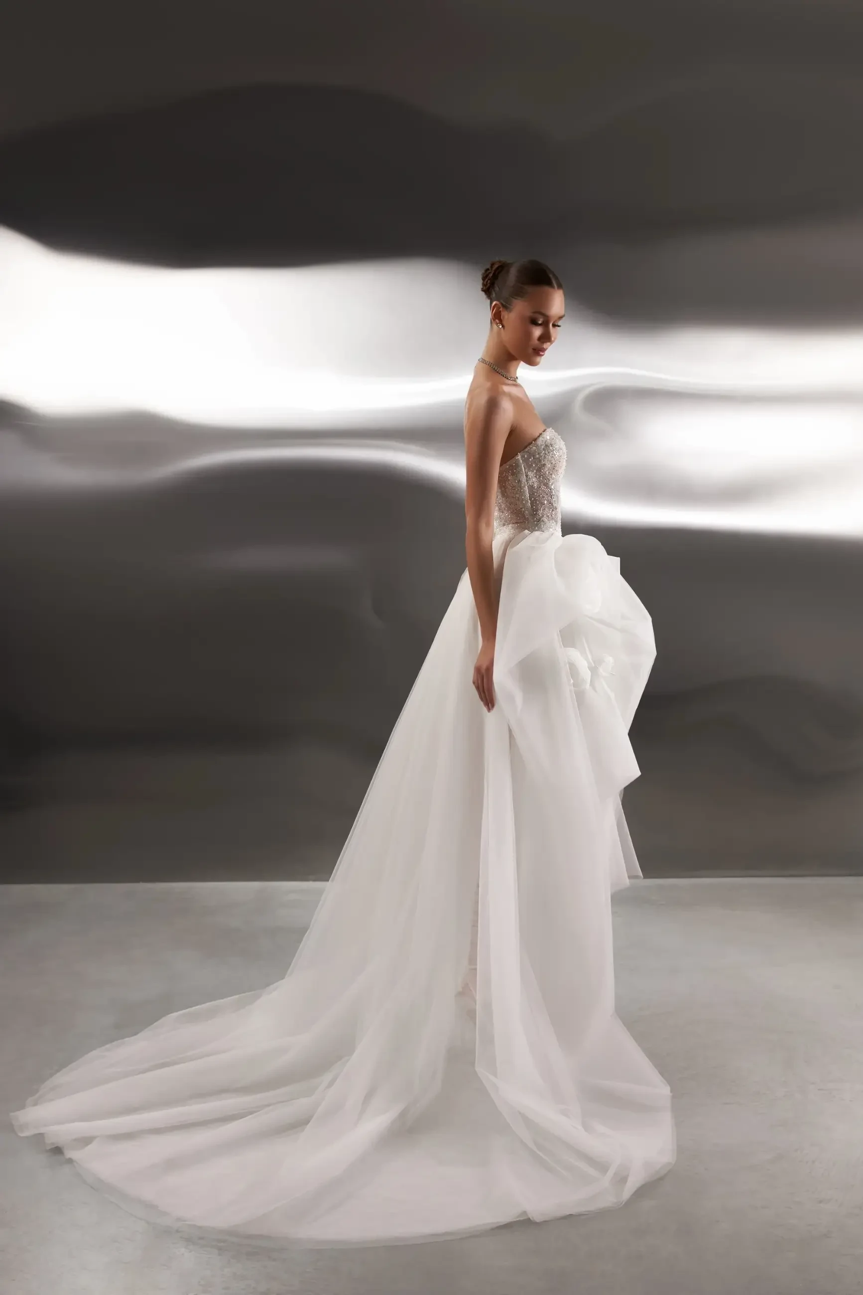 model is wearing a glamorous strapless bridal gown 